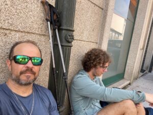 Finding Our Way on the Camino — Christopher Parsons and his son resting along the Camino de Santiago